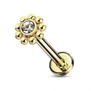 Golden ball and crystal labret ear piercing